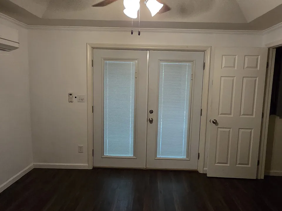 Living room looking at the French doors and coat closet.