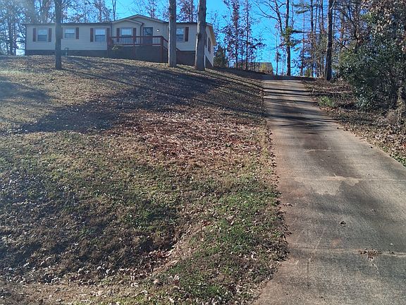 Front with long concrete driveway.