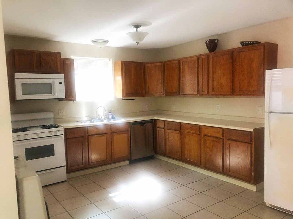 Kitchen area showing Gas stove, microwave, dishwasher and refrigerator.