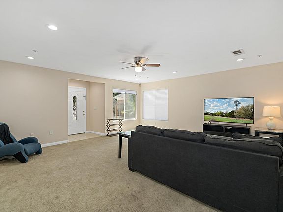 Relax and unwind in our stylishly furnished living room, complete with a cozy sofa and entertainment setup, offering the perfect spot for movie nights or quiet evenings in.