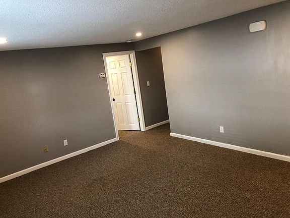 Living room leads to large bedroom and hallway to completely remodeled bathroom.