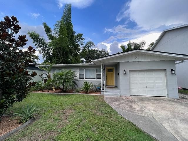 1960's bungalow with parking for 3 cars & mature landscaping.