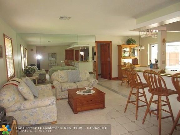 LIVING ROOM AND OPEN BAR WITH STOOLS - GREAT SPACE TO ENTERTAIN.