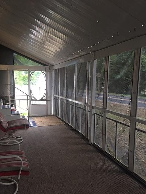THIS IS THE SCREENED PORCH - 8 FT WIDEX 24 FT. LONG. NOTE, THE CHAIRS ARE SPACED FOR SOCIAL DISTANCING. IT HAS SUNSCREENS TO KEEP OUT THE HOT SUN THAT ARE ALSO FOR PRIVACY. YOU CAN SEE OUT BUT NOBODY CAN SEE IN. DON'T KNOW HOW THEY DO THAT.