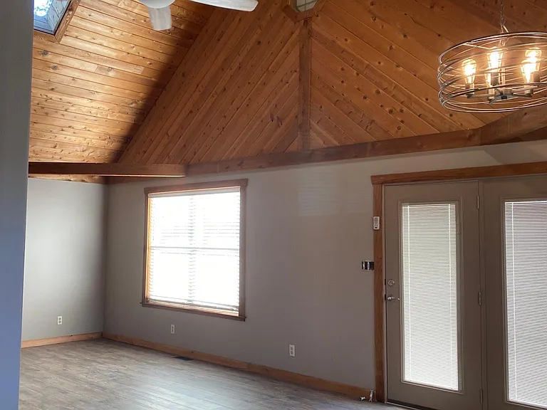 Living room dining room has 18 foot high cedar ceilings with skylightS