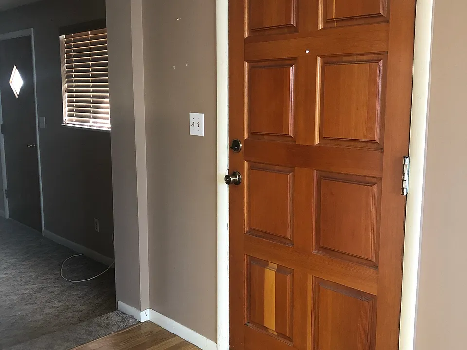Door leading into kitchen and dining area. To the left is a separate living room.