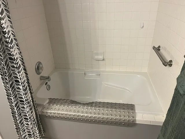 Soaker tub with shower and extra strong arm rail for top drawer support.
