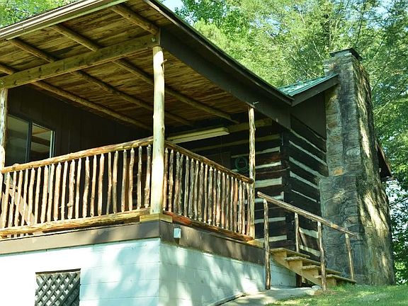 Hand-hewn safety railing on porch, steps and railing