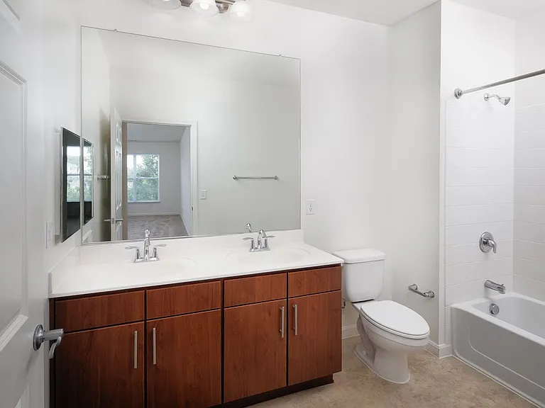 Classic Package bath with oak cabinetry and tile flooring