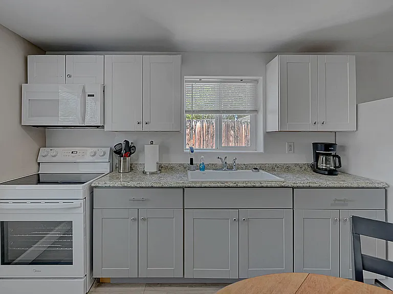 Full kitchen with modern cabinetry, full-size appliances, and ample counter space