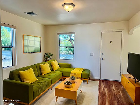 Livingroom with beautiful wood laminate flooring and lots of natural light.