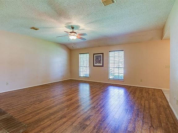 Freshly remodeled flooring in this extra large living area space for entertaining.