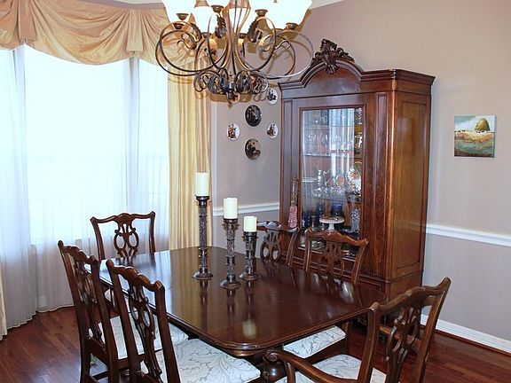Large Formal Dining Room w/bay window, chair rail and warm, soft colors