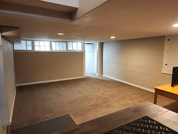 Living area and bonus room/office with a closet behind