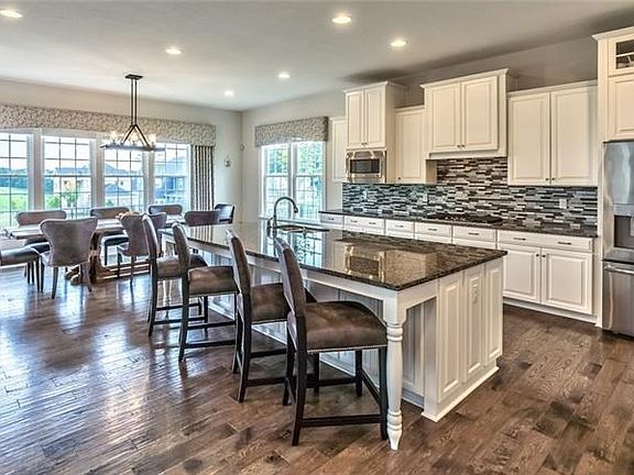 The kitchen is fully upgraded with the state-of-the-art stainless appliances, as well as all white cabinetry and granite counter