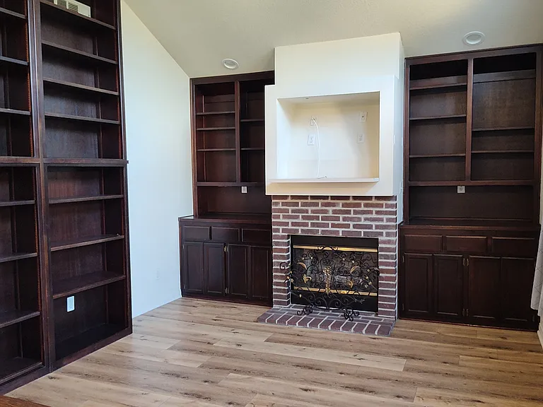 spacious, light filled den with storage and book shelves