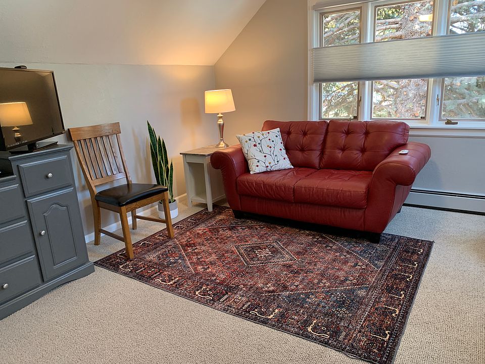 Large windows, skylights, and smart TV in living area.