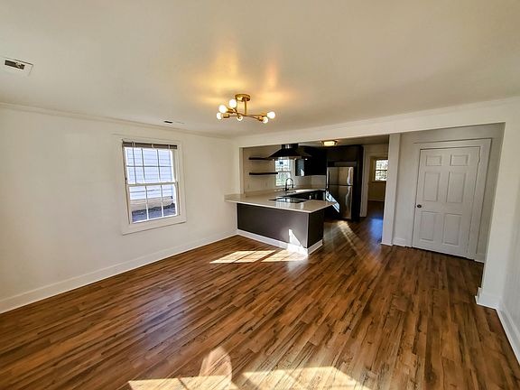 Spacious open living and kitchen setup with plenty of windows and lots of natural lighting