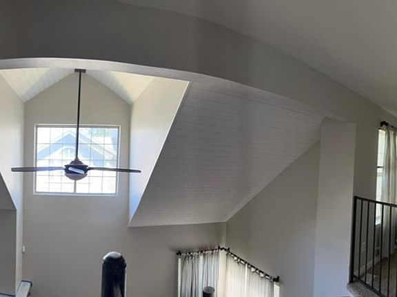 Vaulted ceiling with fan with lots of natural light