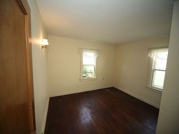 main floor bedroom 1 with hardwood floors