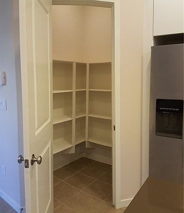 Walk-in pantry with built-in shelves