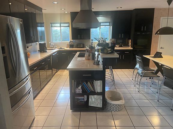 Kitchen, electric stovetop island, limestone kitchen table seats 8