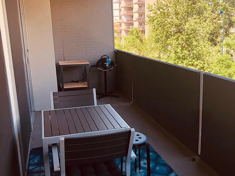 Spacious balcony with wall for safety, electric grill, dining for 4, lounge area and more.