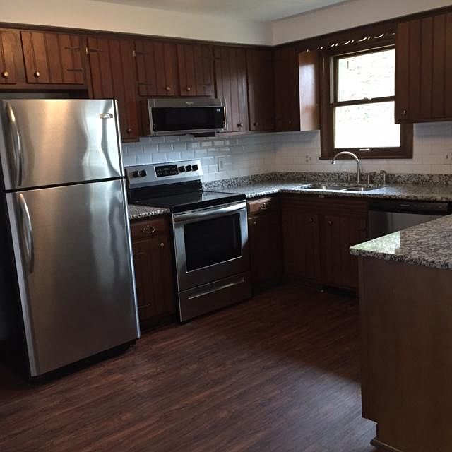 Stainless steel appliances. New range, microwave and dishwasher. New granite countertops, subway tile backsplash and stainless sink.