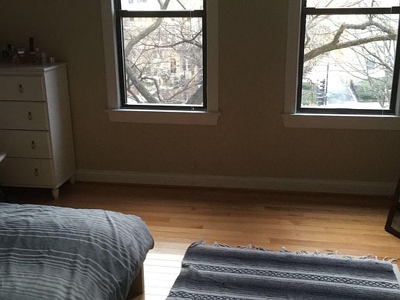 Large bedroom with lots of light and views of trees