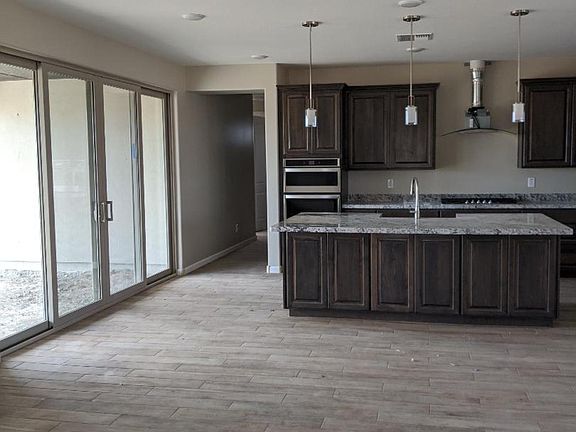 Double Sliding Glass Doors-Granite Counters-Glass Stove Hood-Microwave and Oven-Farm Trough Sink