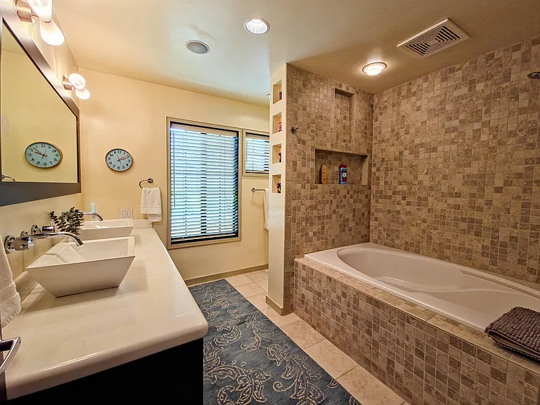 Primary bathroom with large bathtub combination shower.