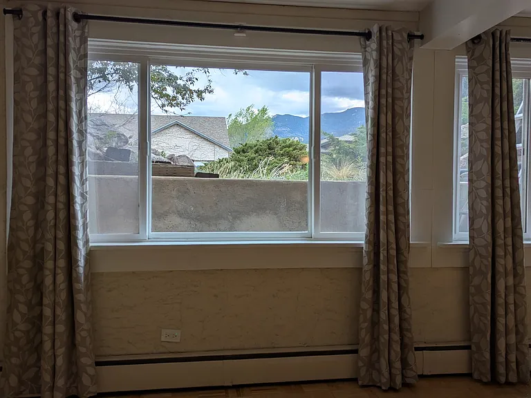 Basement living room with egress window. Could be used as a bedroom.