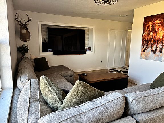 Living Room (door at back of photo is master; tv in photo is a 75", for reference)