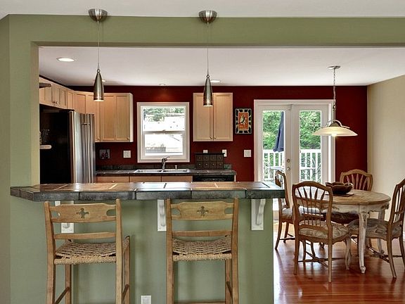 Cozy up to the tiled eating bar! Throw open the French doors (new in 2012) to extend out onto the deck.