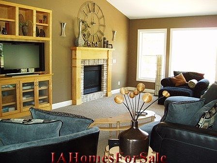 Step seamlessly from the kitchen to the sun-drenched living area with gas fireplace and custom built-ins done up in maple.