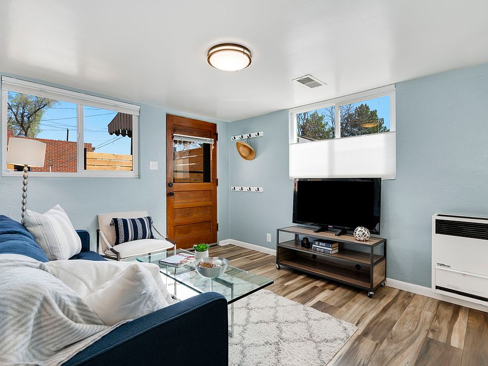 Living room is light and bright, with up/down window blinds and new flooring