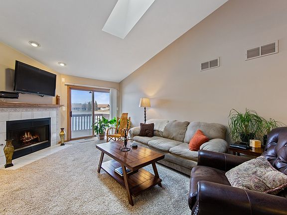 Living Room with Lake Views, skylight, Fireplace, access to the Deck.