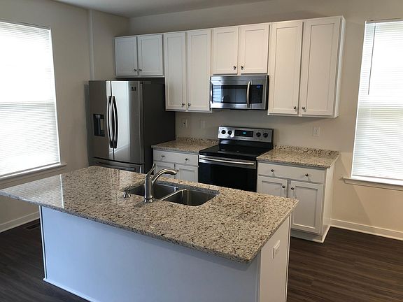 All brand new stainless steel appliances, granite counter tops with a breakfast bar in kitchen