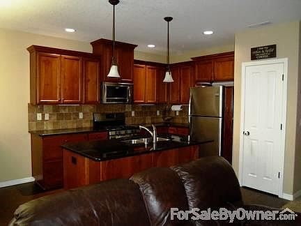 Living Room View from Kitchen
						:
						Wall mount space for TV, gloss finish Granite Island