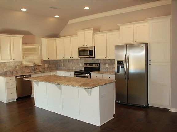 Tons of gorgeous white cabinetry, granite counters, stainless appliances, and huge island, great for entertaining!