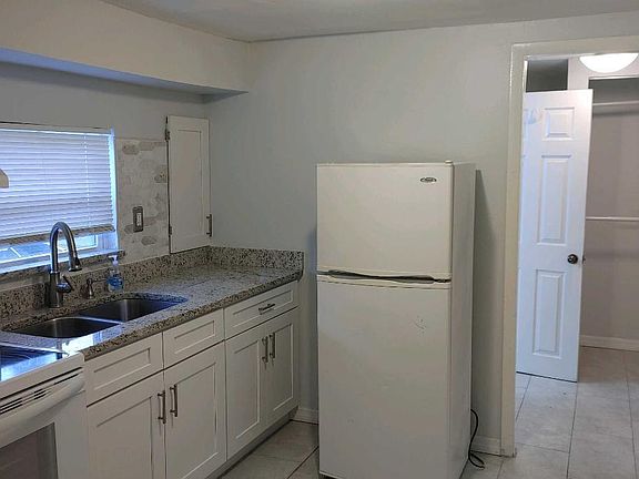 View of Kitchen towards closet down the hall.