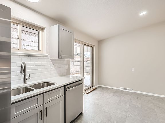 Upgraded kitchen sink and dining area with view outside