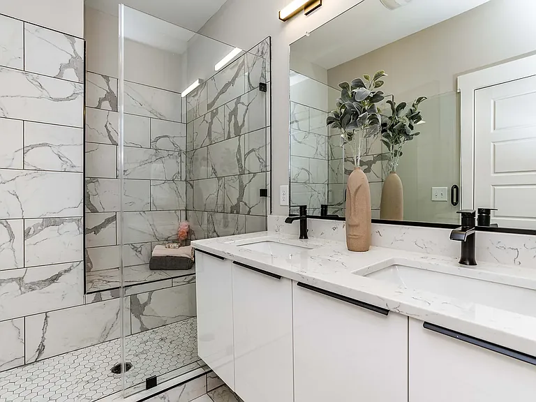 Large luxurious walk-in tile shower with suspended vanity.