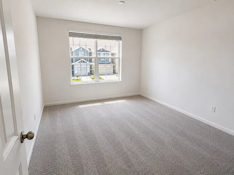 Comfortable third bedroom perfect for family, guests, or a home office.