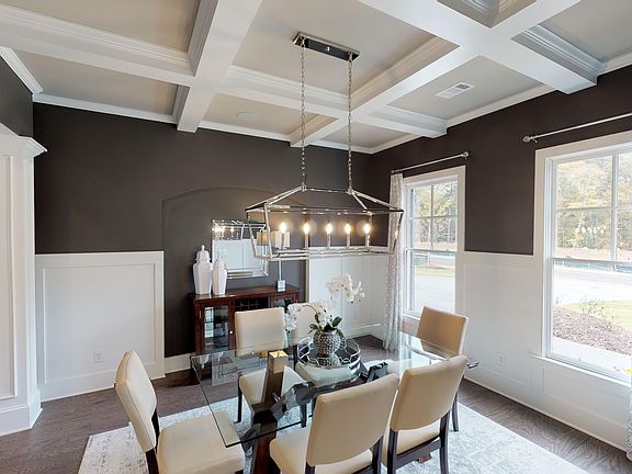 Dining Room with large windows, coffered ceiling and generous molding.