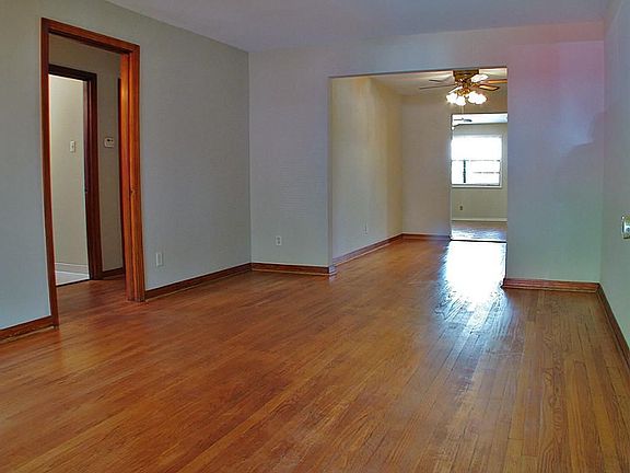 This is a view from the living room, through the dining room and into the den. Beautiful hardwood fl