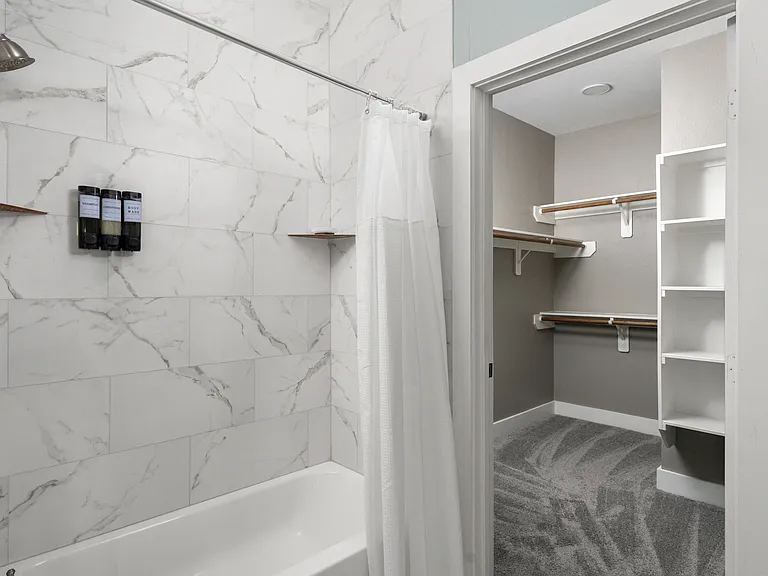 Ensuite bathroom also connects to a spacious walk-in closet.