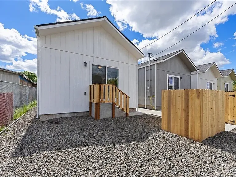 Back of units showing Unit B backyard and parking