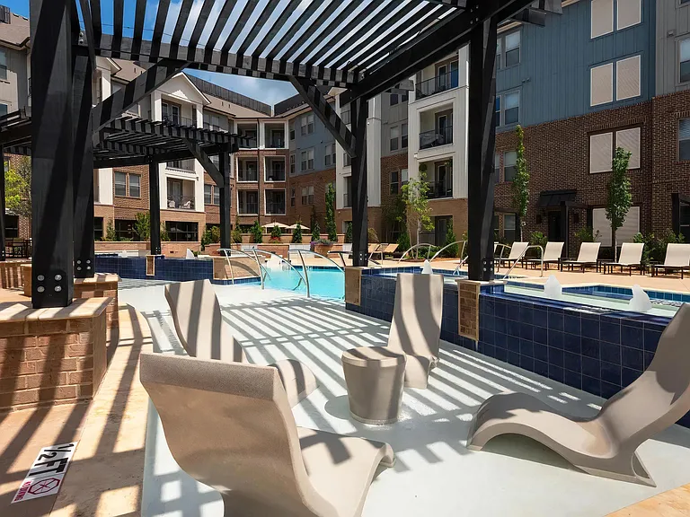 Poolside Pergola with In-Water Loungers and Modern Seating