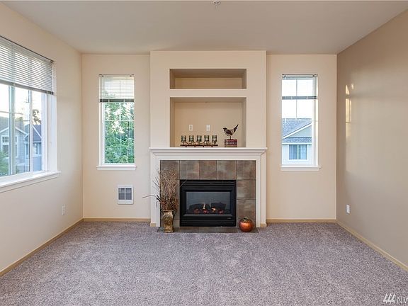 Electric fireplace has a beautiful tile surround